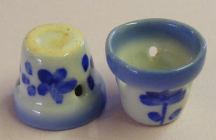 1 small round blue floral ceramic pot with a hole