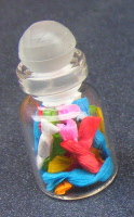 a dolls house miniature sweets in a jar wrapped toffees