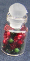 a dolls house miniature sweets in a jar wrapped